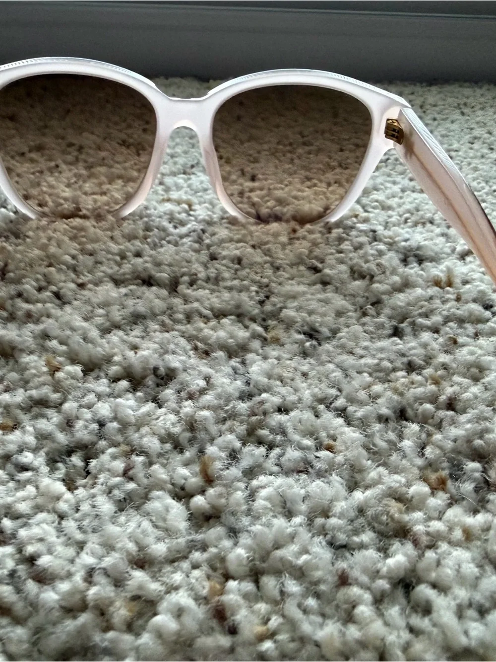 Tory Burch Pale Pink Frame Sunglasses with cat eye shape with gold detail.